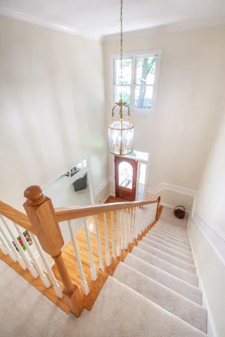 A grand two-story entryway features a hanging lantern, creating a welcoming first impression.