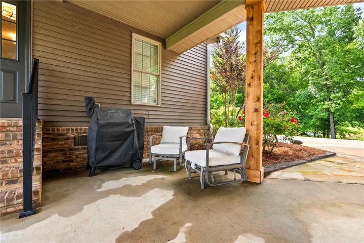 A tranquil covered patio offers an inviting space for outdoor relaxation and entertaining.