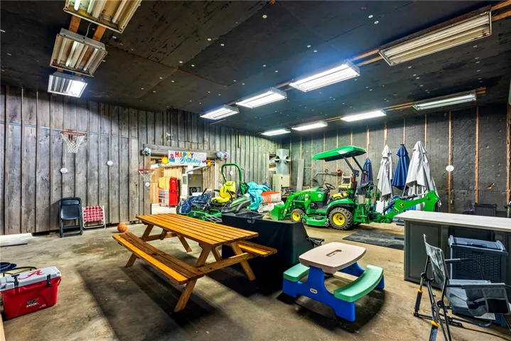 Spacious garage with robust wood paneling, offering ample storage and workshop potential.