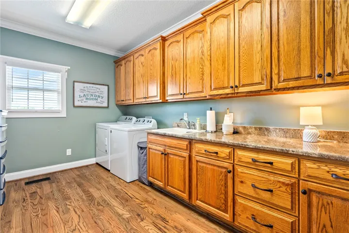 Ample cabinetry and generous counter space define this functional and well-appointed utility area.
