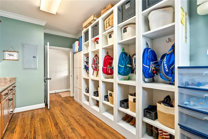 Custom built-in cubbies and warm wood flooring provide a functional, organized entry.