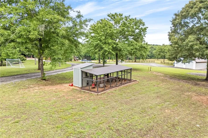 An impressive chicken coop, a functional and aesthetically pleasing addition to this expansive yard.