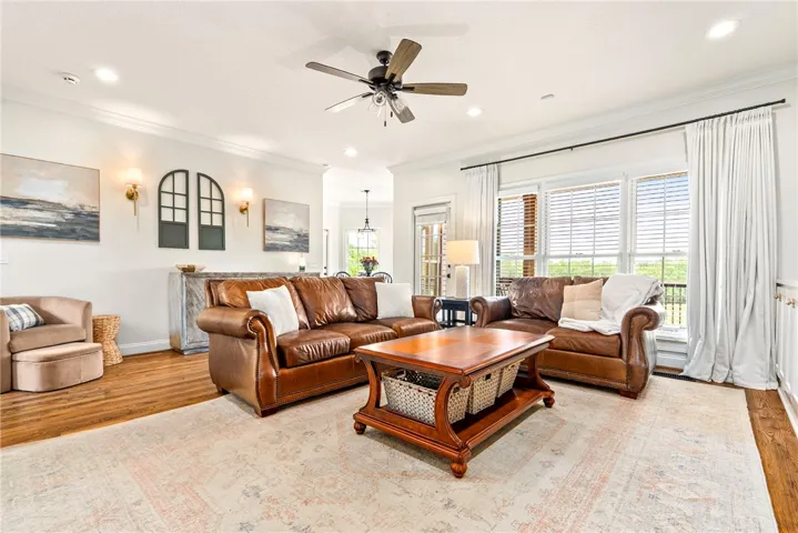 A comfortable living area features rich hardwood floors and abundant natural light.