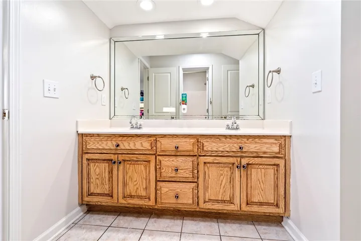 Double vanity with ample storage awaits in this well-appointed bathroom.