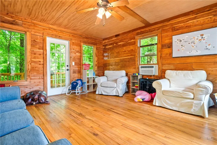 Natural wood paneling throughout creates a cozy, rustic living space.