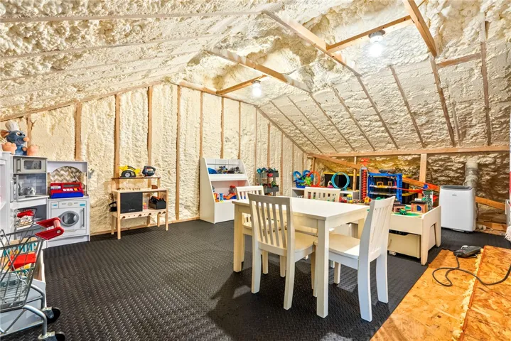 An insulated attic space offers versatile utility for storage or recreational pursuits.