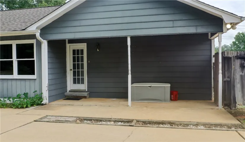 Covered entry into laundry room & kitchen area.