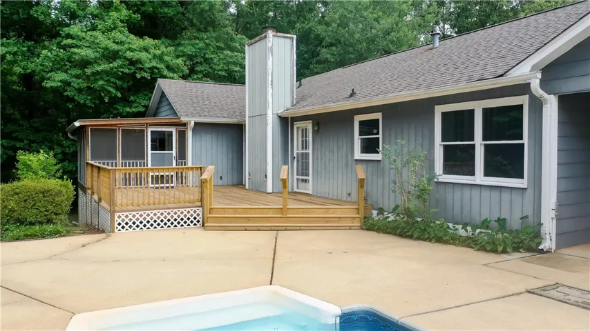 Wooden deck and screened porch extend from this charming home, ideal for outdoor fun or entertainment.