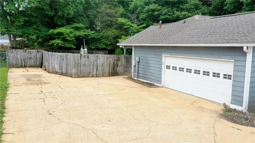 Double garage with space for a workbench or additional storage.