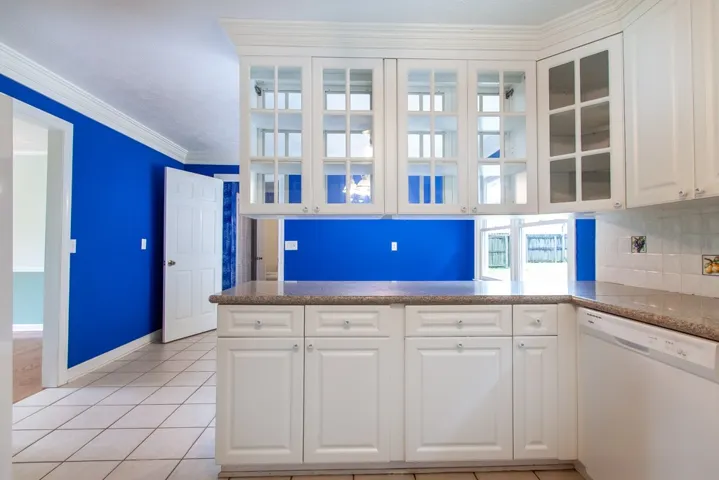 Beautiful white, glass- front cabinetry in kitchen.