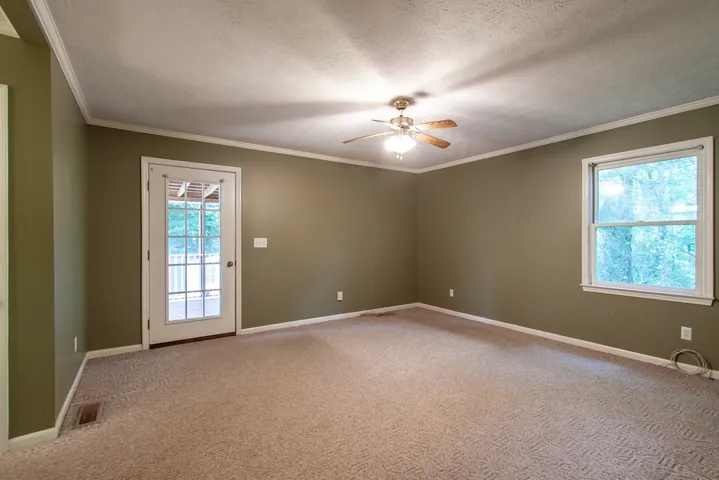 Primary bedroom opens onto screened-in porch.