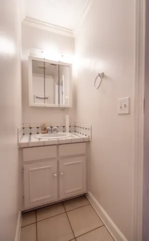 Half-bath conveniently located in laundry room, near pool.