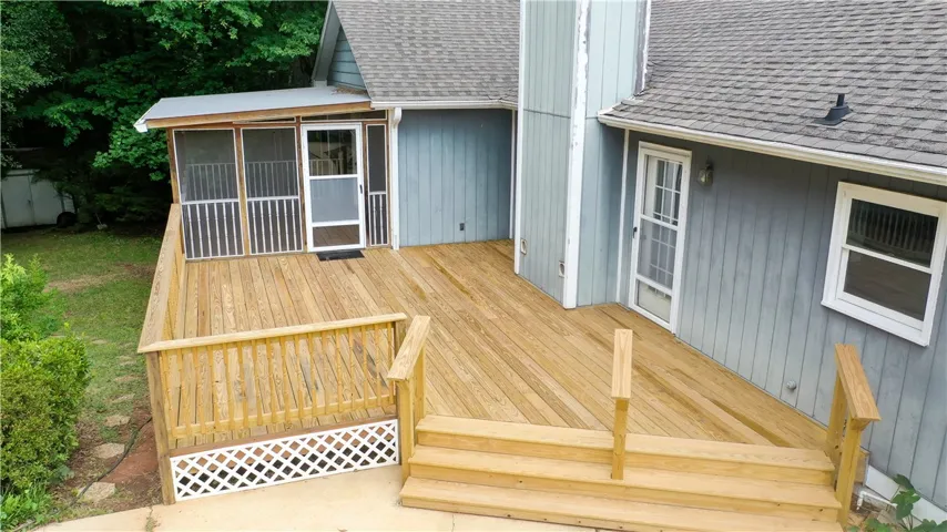 Screened porch and deck overlook pool.
