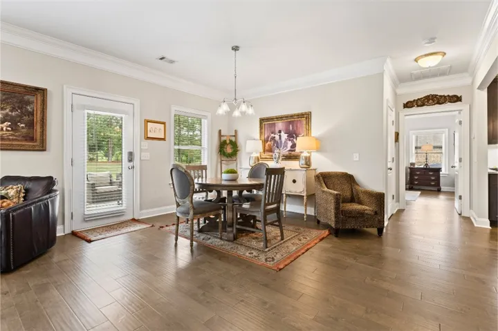 Sun-filled dining area offers a seamless flow to the outdoors with classic hardwood flooring.