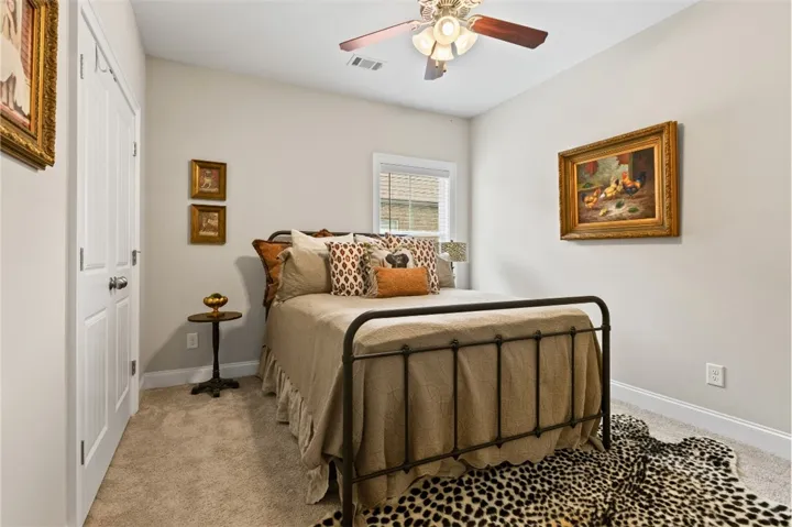 Comfortable bedroom with neutral tones and a refreshing ceiling fan.