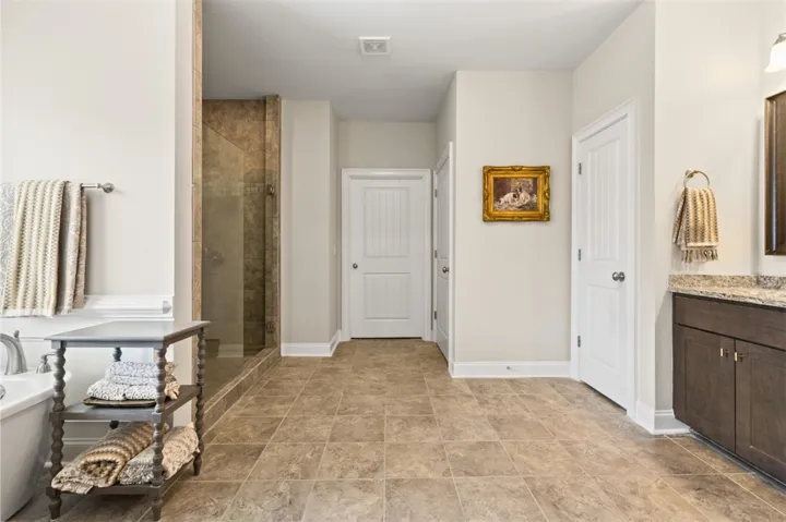 A well-appointed bathroom features an integrated shower and a functional vanity with elegant countertops.