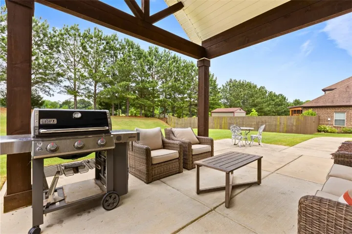 A spacious covered patio offers ample room for outdoor dining and comfortable seating.