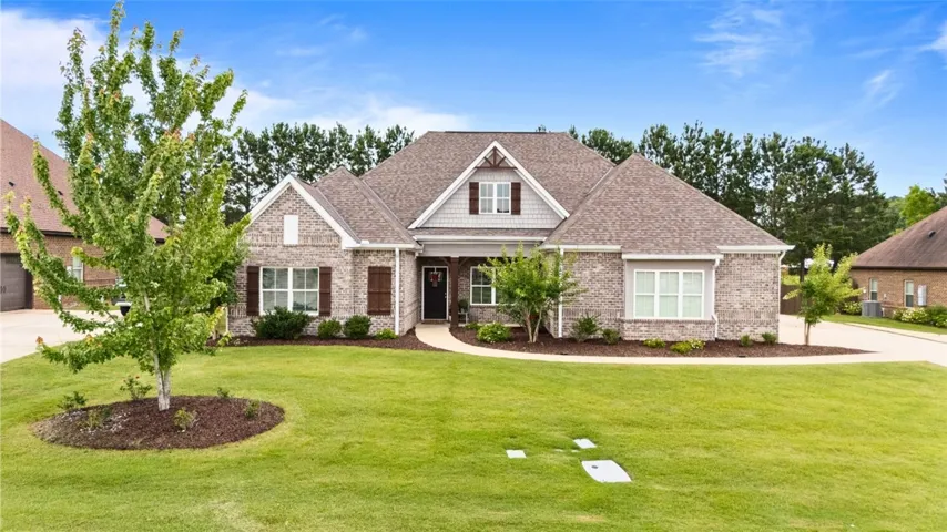 A classic brick exterior with inviting front porch creates wonderful curb appeal.