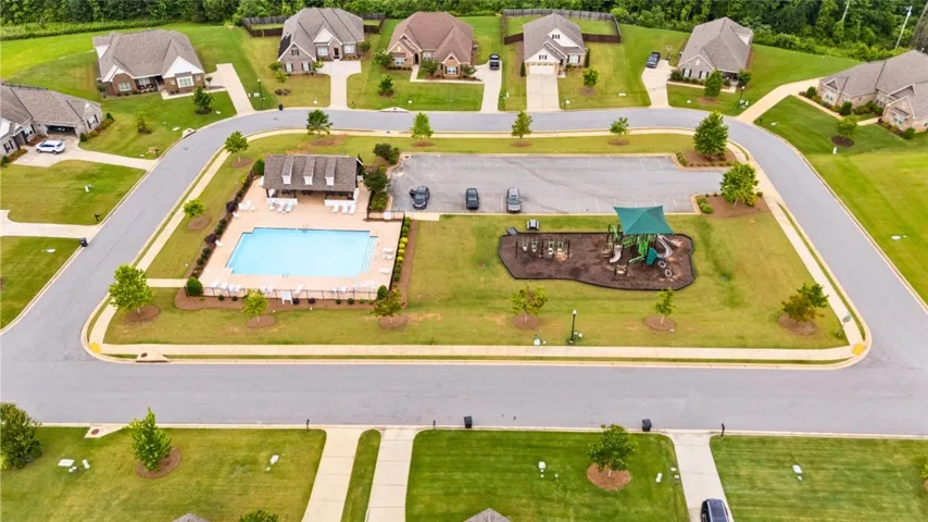 An inviting community hub with a shimmering pool and vibrant playground awaits.