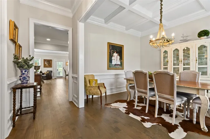 Hardwood floors and coffered ceilings define this elegant dining space, perfect for entertaining.