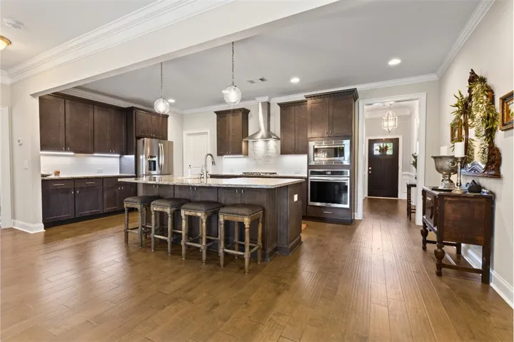 Culinary delights await in this modern kitchen with rich cabinetry and an inviting island.