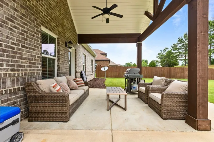 An inviting outdoor living space features a covered patio perfect for entertaining and relaxation.