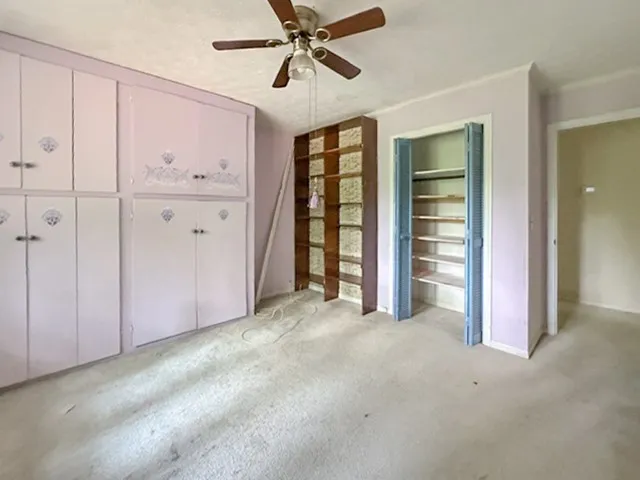 Functional built-in cabinetry provides ample storage in this versatile living space.