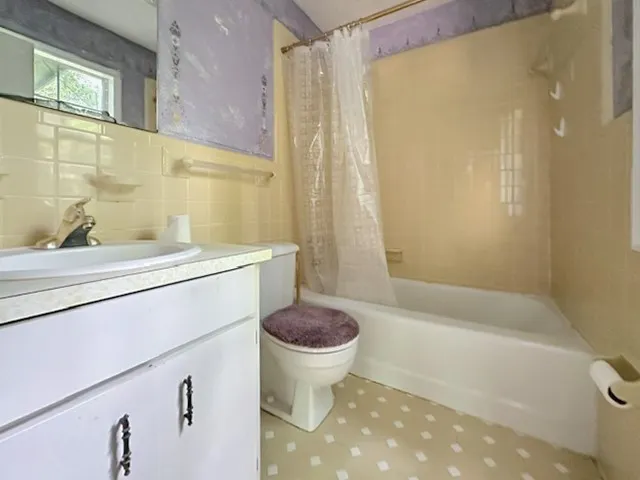 Functional full bathroom with a spacious vanity and a combination shower/tub.