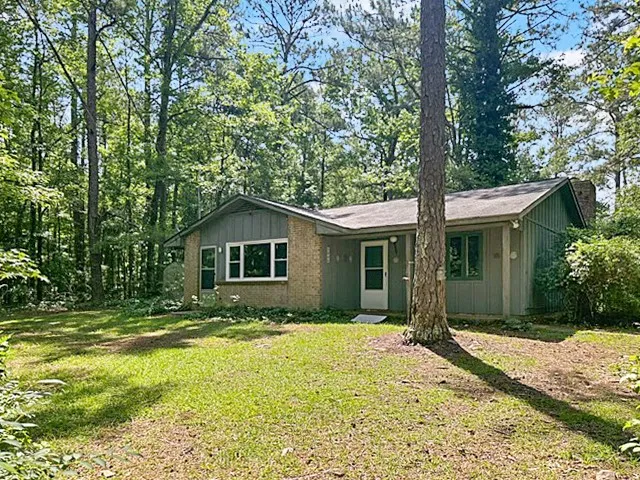 A secluded retreat nestled in a tranquil wooded setting, offering a peaceful residential experience.