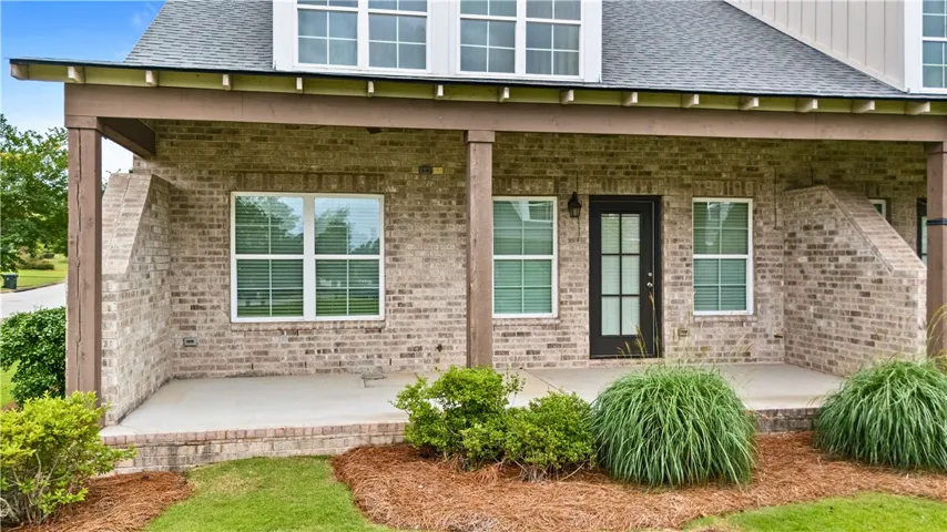 A well-maintained brick exterior with an inviting covered patio, ideal for outdoor relaxation.