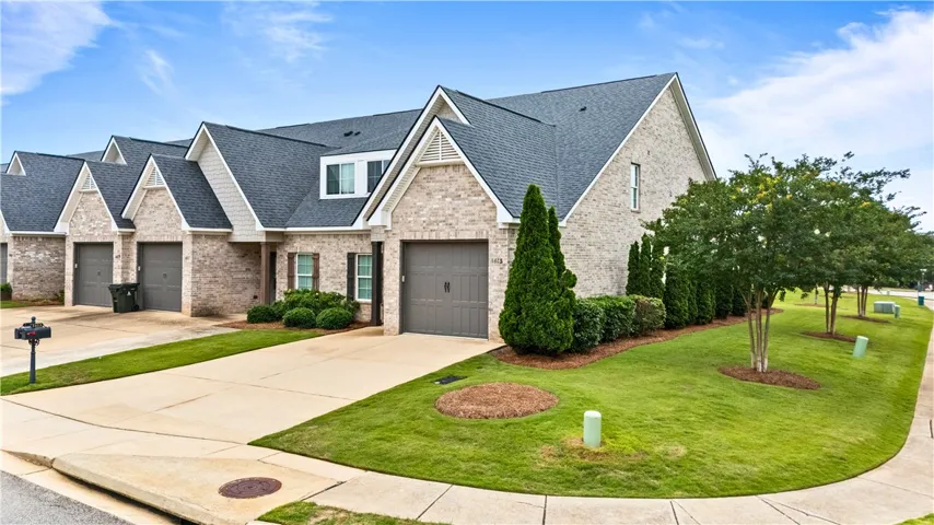 A well-maintained facade of brick and siding with tidy landscaping enhances the home's curb appeal.