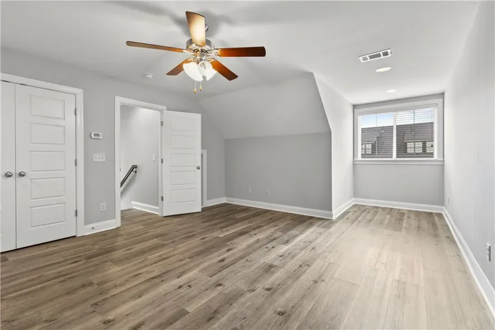 A versatile bonus room featuring sleek wood flooring and a bright window.