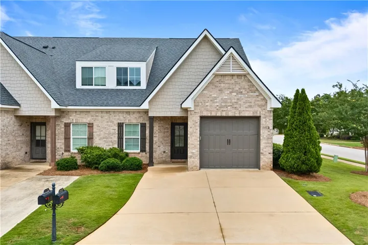 A well-maintained facade with brick and shingle accents welcomes you home.