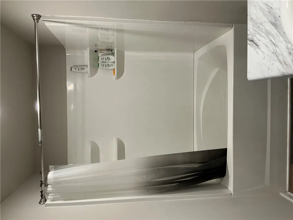 A pristine shower-over-tub combination offers comfort and utility.