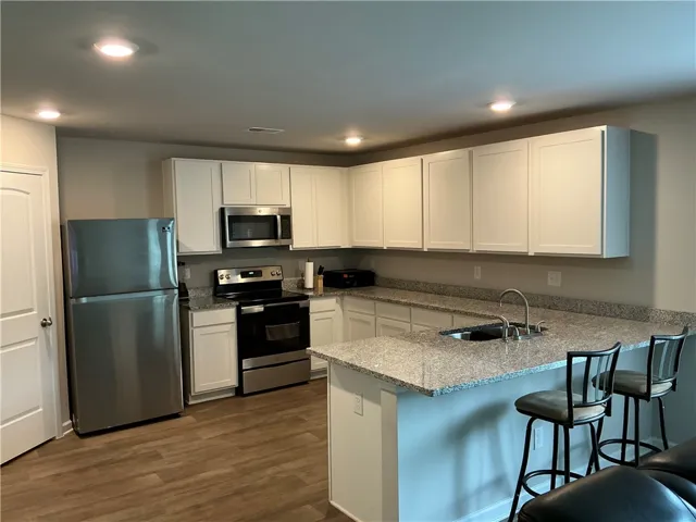 A well-appointed kitchen boasts sleek stainless steel appliances and abundant counter space.