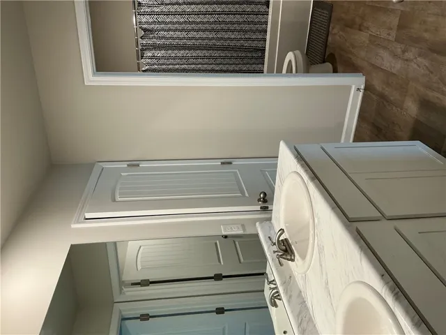 Double vanity with pristine marble counters offers abundant space and convenience.