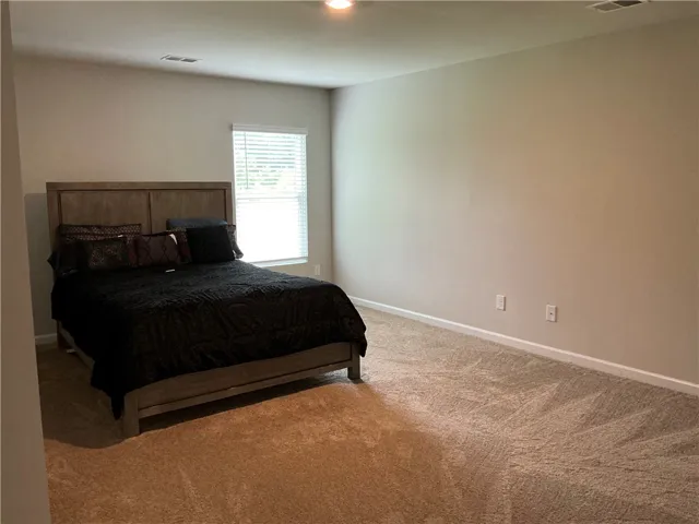 A spacious sleeping area with neutral tones, providing a restful sanctuary.