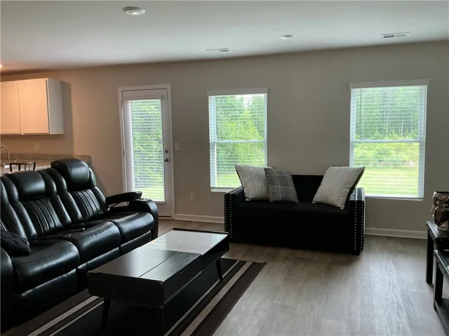 An open floorplan living area flows seamlessly into the adjacent kitchen.