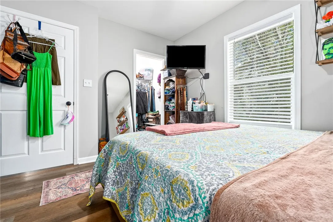 An inviting bedroom with resilient wood flooring and a conveniently located walk-in closet.