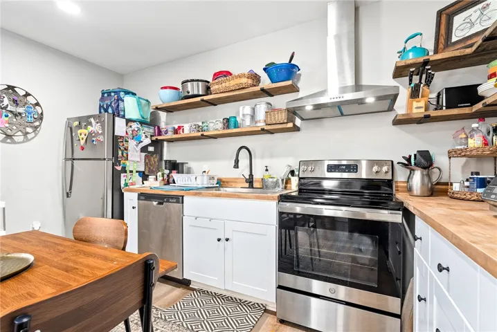 Functional kitchen with ample counter space and storage on open shelving.