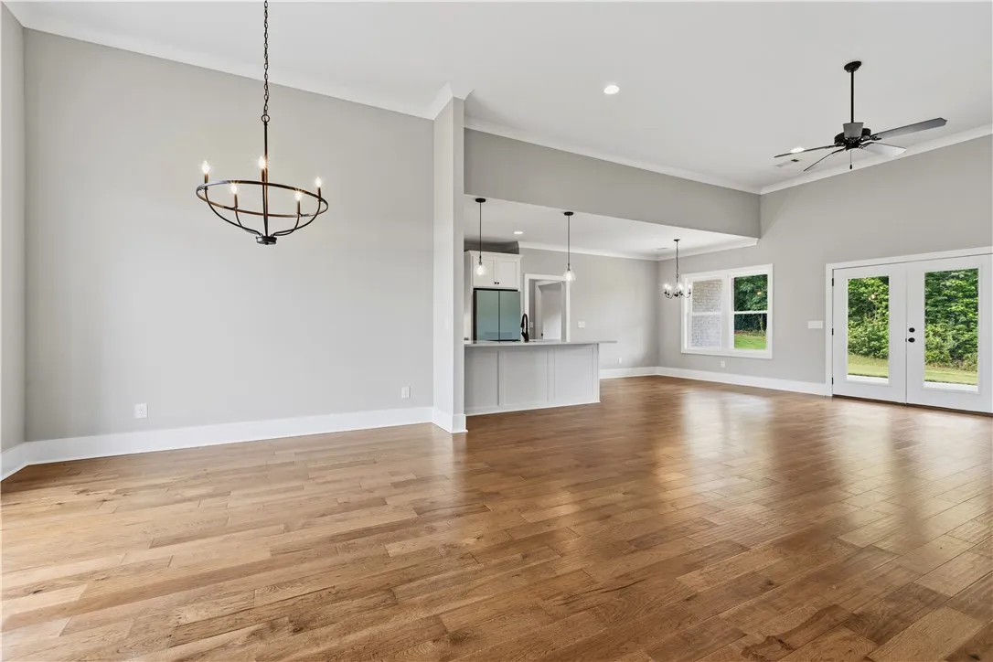 Natural light floods this inviting living space, highlighting the rich hardwood flooring and vaulted ceilings.