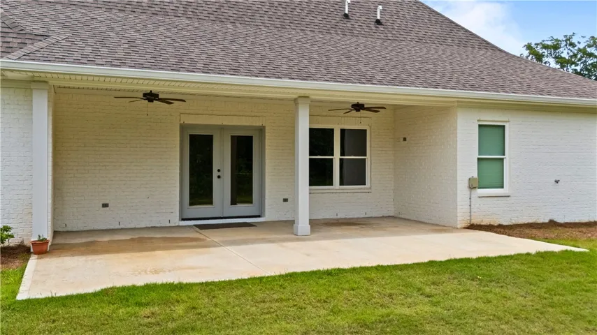 An inviting covered patio extends from the home, perfect for outdoor relaxation.