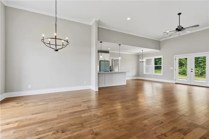 Natural light floods this inviting living space, highlighting the rich hardwood flooring and vaulted ceilings.