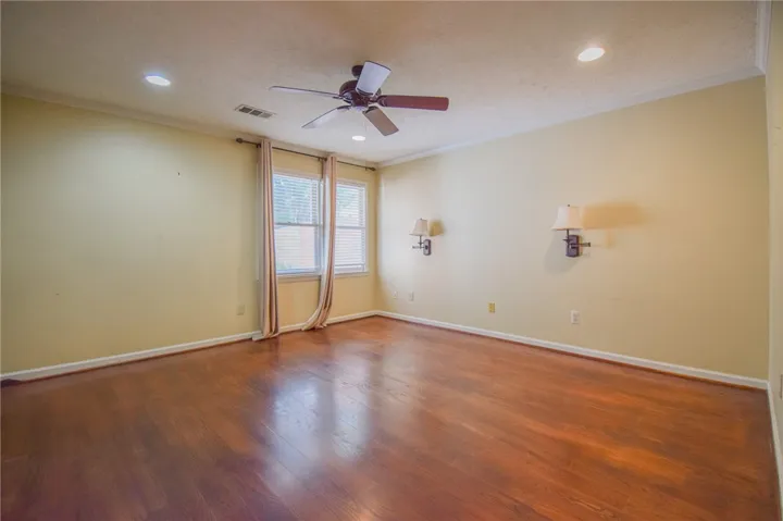 Hardwood floors and generous windows illuminate this inviting living space.