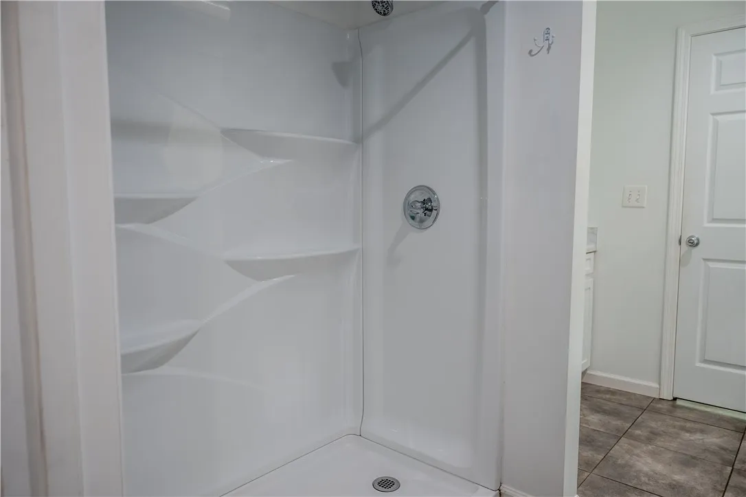 A well-maintained shower stall offers convenience and utility in this bathroom.