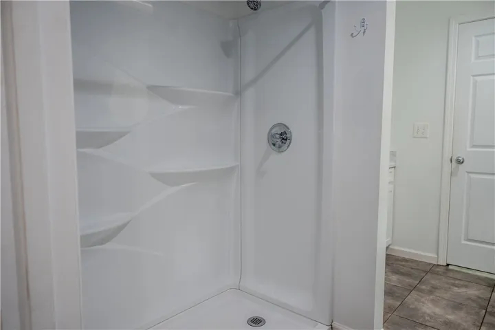 A well-maintained shower stall offers convenience and utility in this bathroom.