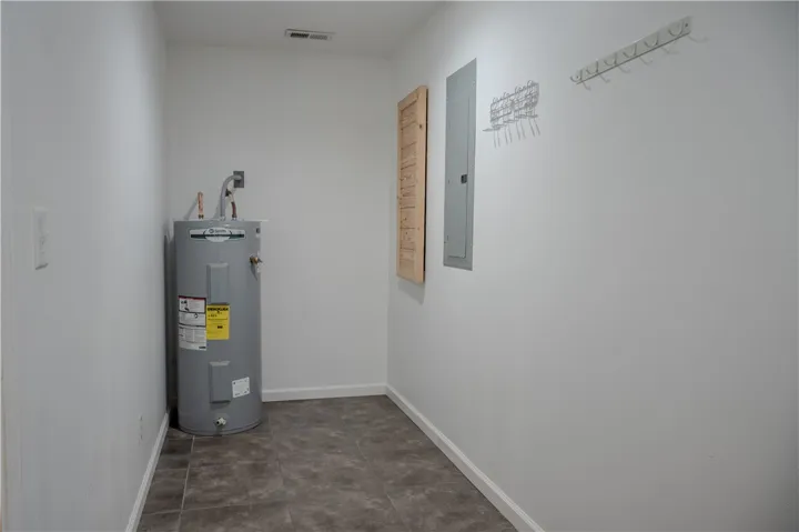 Essential utilities are neatly contained in this practical and well-maintained utility area.