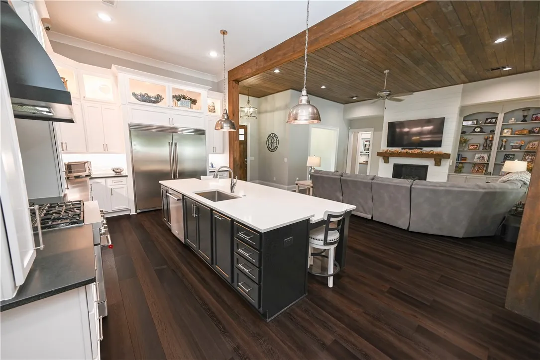 An open concept design seamlessly connects the gourmet kitchen to the inviting living area.