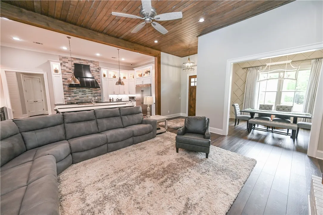 A thoughtfully designed open plan seamlessly blends the great room, dining room, and kitchen into one expansive yet inviting central living space.