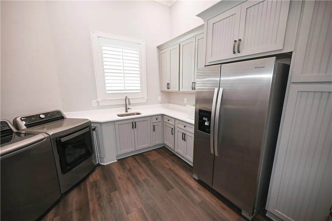 Ample counter space, sink, storage, and window make laundry (almost!) enjoyable.....